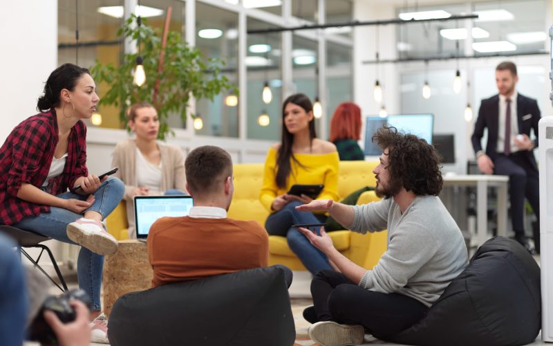 business people group in modern office have a team meeting and brainstorming while working on tablet or laptop presenting ideas and take notes